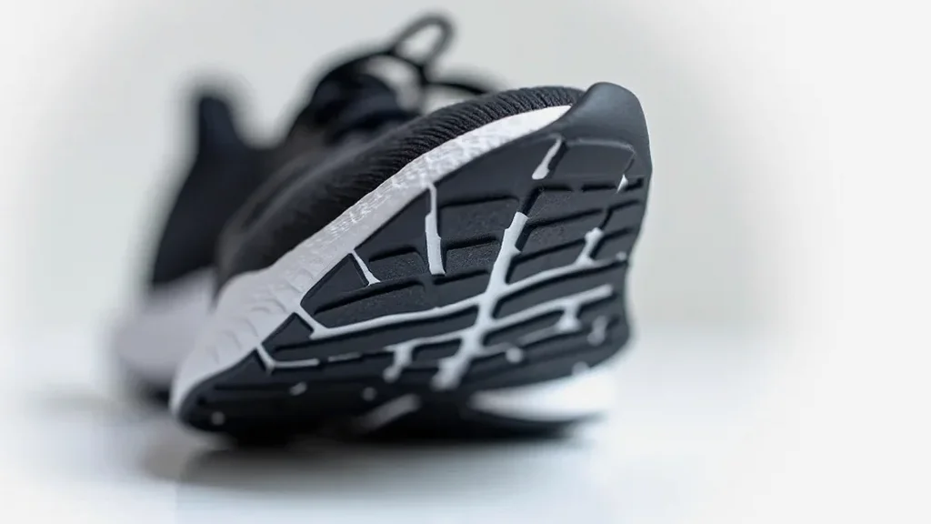 Detailed close-up of a high-end running shoe sole and tread design, revealing build quality and material craftsmanship